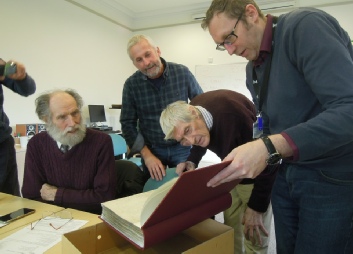 Paul Ransley (second left) admires the newly conserved Fowler register with (left to right) the late Mike Beeby, the late Mike Goodman and Guy Baxter, Associate Director, Archive Services, MERL